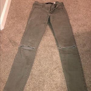 army green skinny jeans with rips in knees